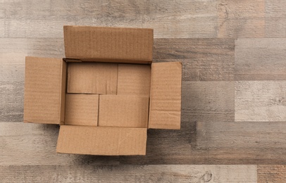 Photo of Cardboard box on wooden floor