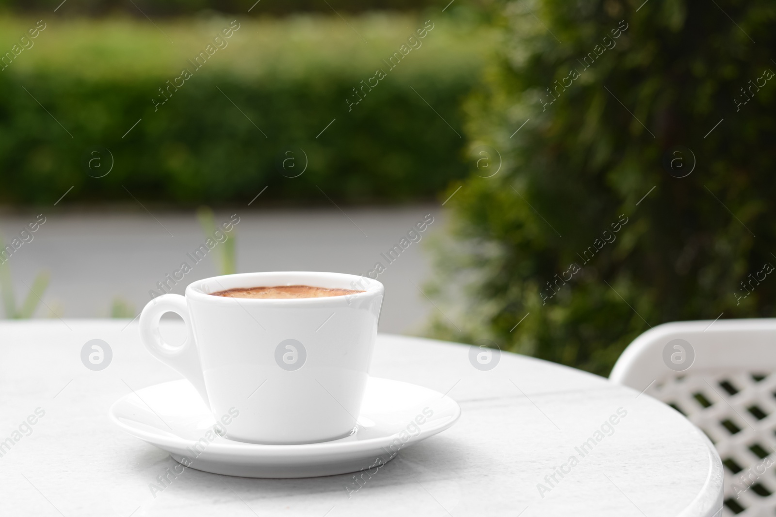 Photo of Ceramic cup of aromatic coffee on table in morning, space for text