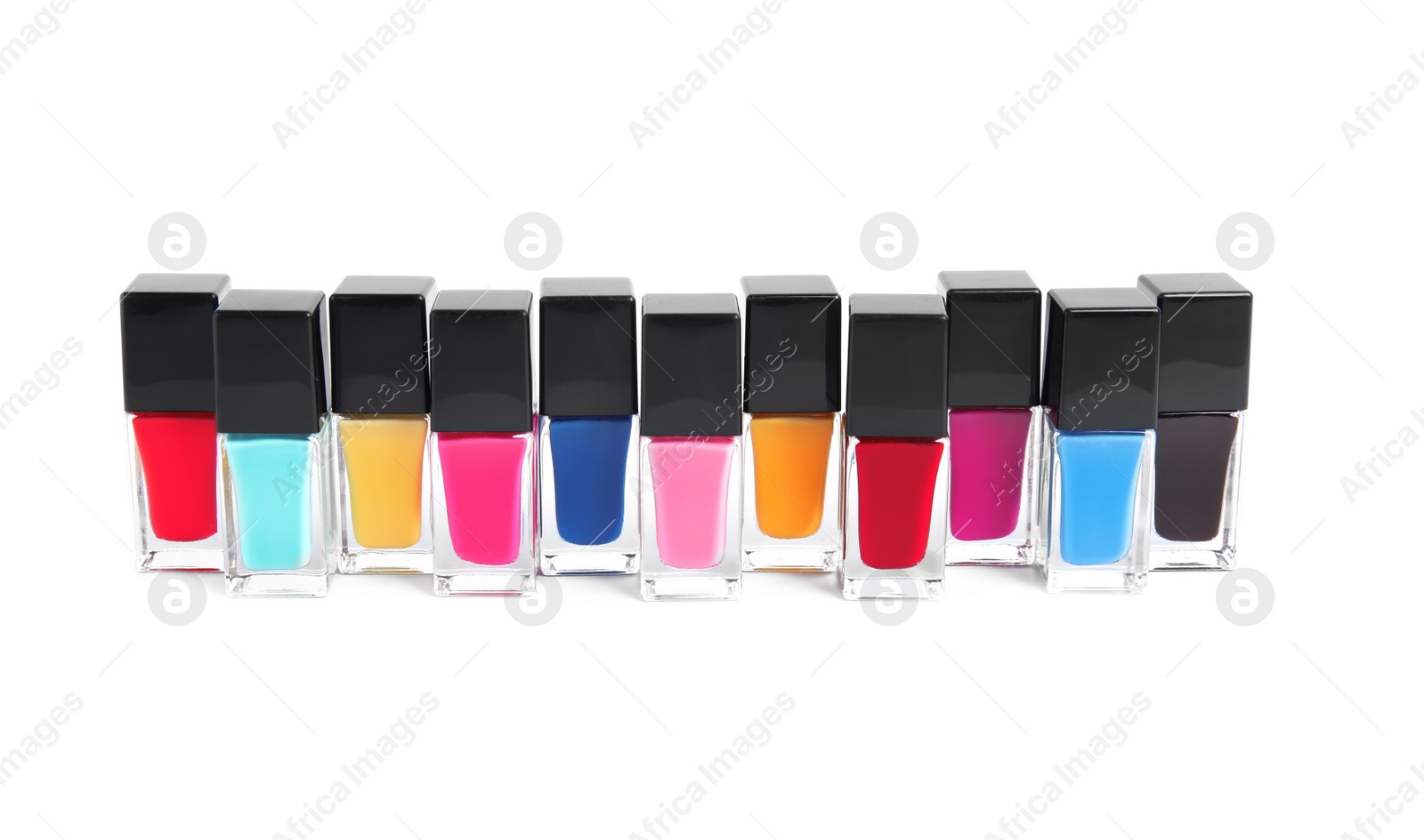 Photo of Bottles of nail polish on white background