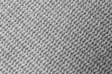 Photo of Grey knitted fabric as background, top view