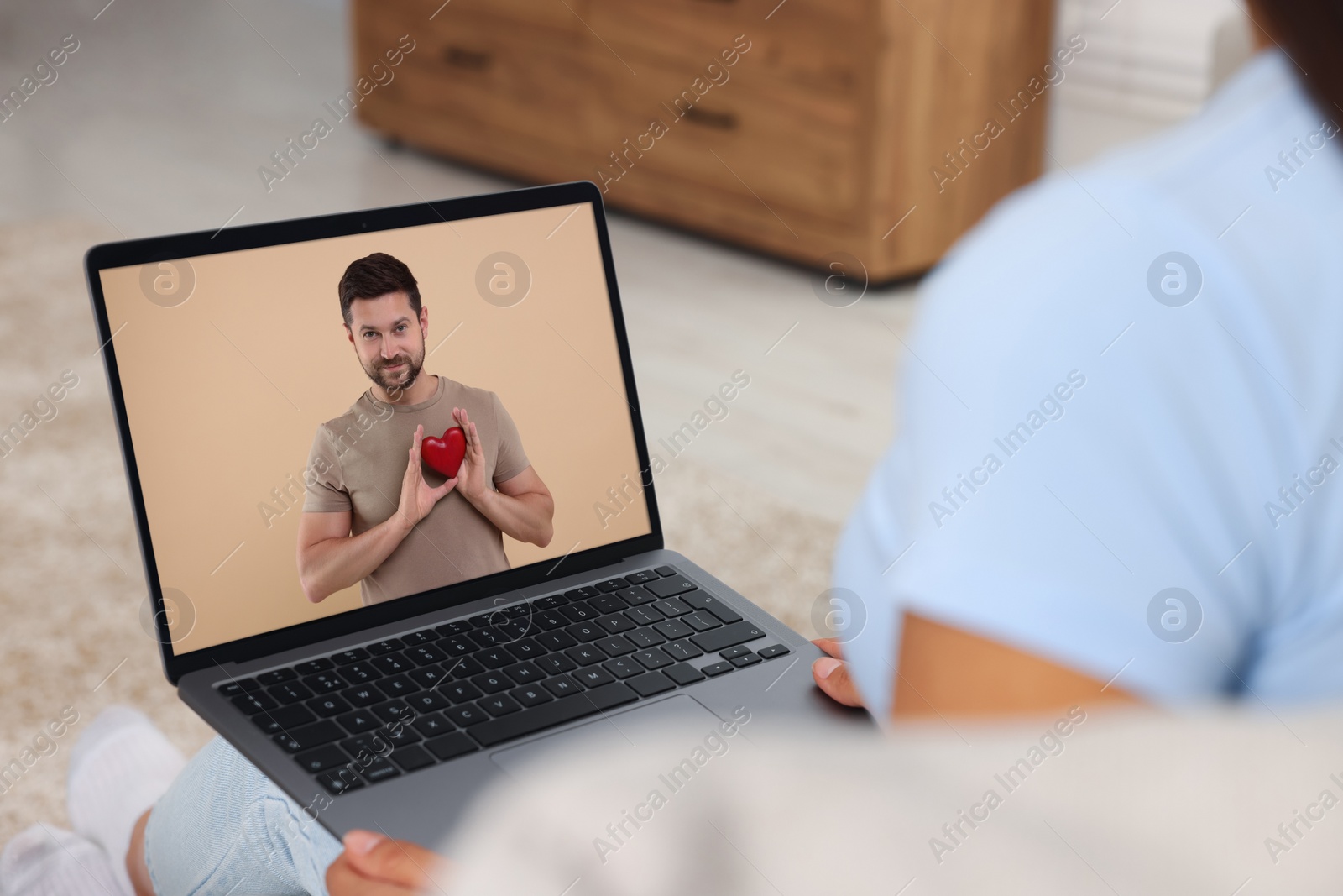 Image of Long distance love. Woman having video chat with her boyfriend via laptop at home, closeup