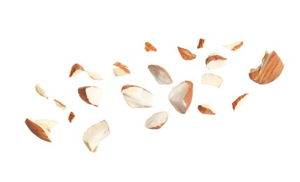 Pieces of tasty almonds on white background