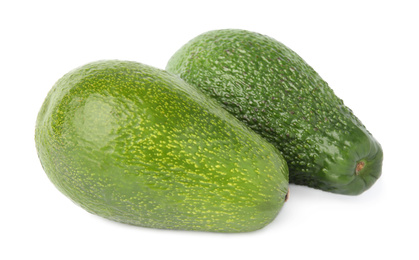 Photo of Tasty ripe avocados on white background. Tropical fruit