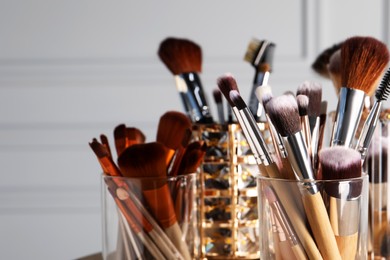 Photo of Set of professional makeup brushes indoors, closeup