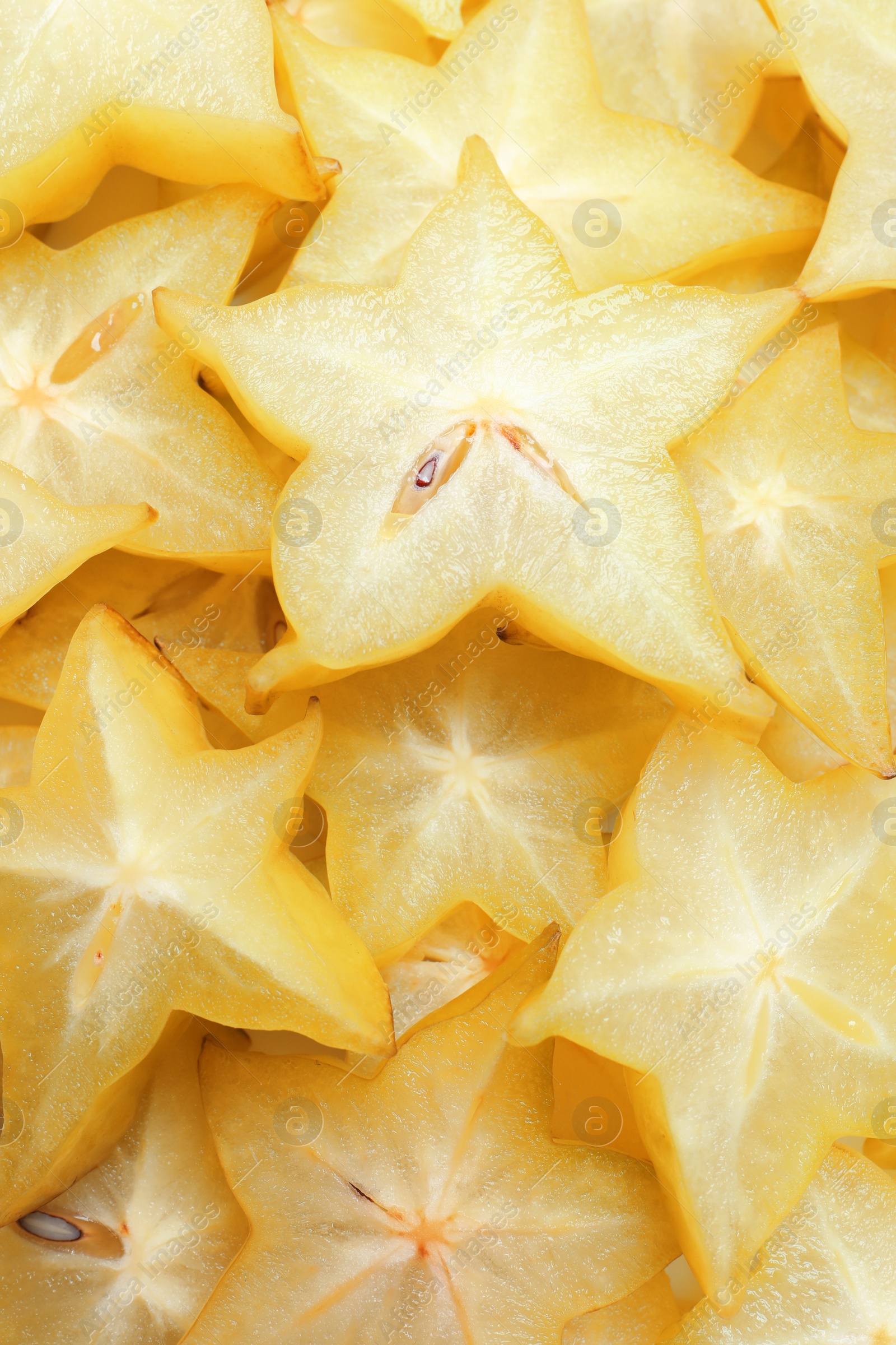 Photo of Pile of delicious carambola slices as background, top view