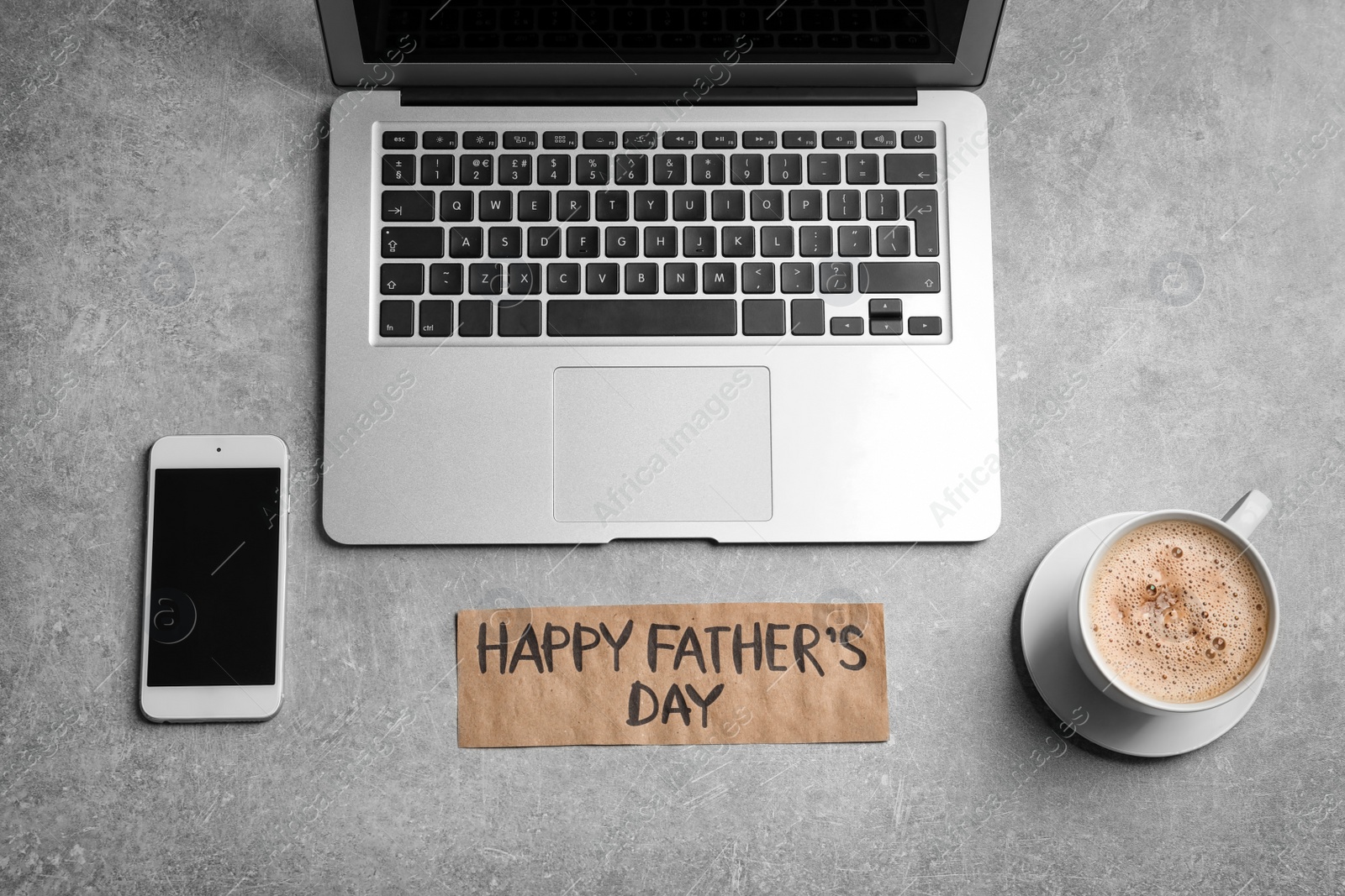 Photo of Smartphone, laptop, cup of coffee and card with words HAPPY FATHER'S DAY on grey background, top view