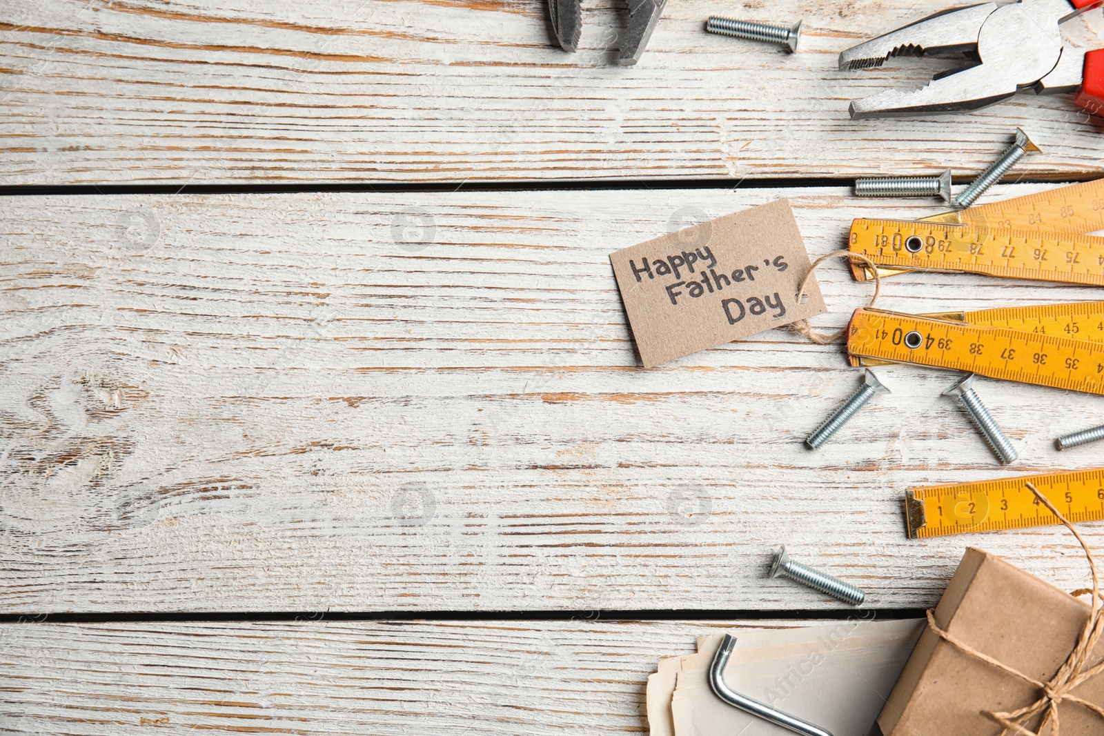 Photo of Flat lay composition with different tools on white wooden background, space for text. Happy Father's Day