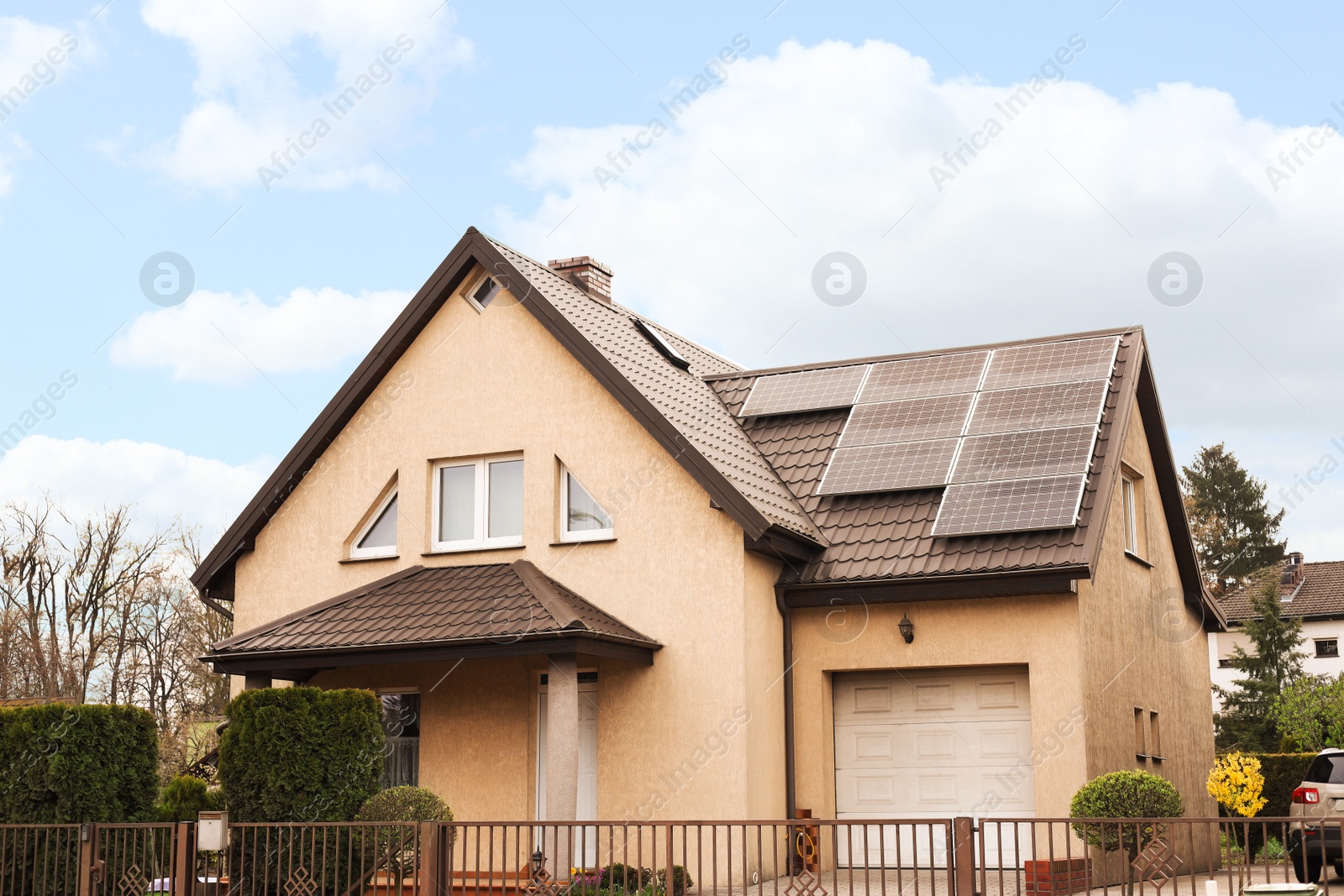 Photo of House with installed solar panels on roof. Alternative energy