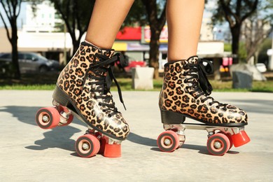 Woman in stylish roller skates outdoors, closeup