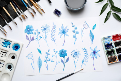 Photo of Flat lay composition with floral picture and watercolor paints on white background