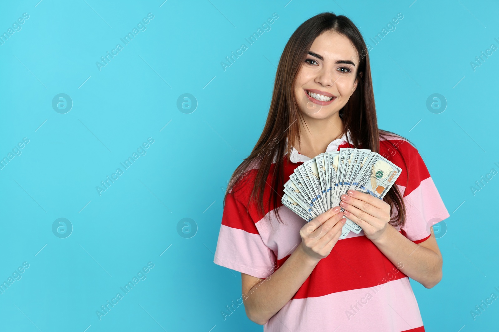 Photo of Young woman with money on color background. Space for text