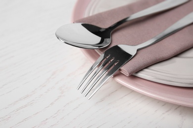 Beautiful table setting on white wooden background, closeup