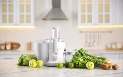 Photo of Modern juicer, fresh vegetables and fruits on table in kitchen