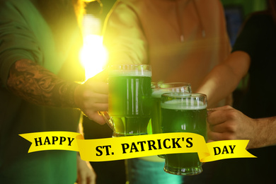 Image of Group of friends toasting with green beer in pub, closeup. St. Patrick's Day celebration