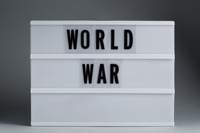 Photo of Lightbox with words World War on light grey background