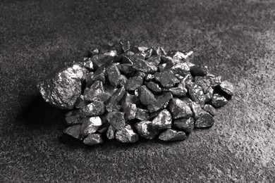 Pile of silver nuggets on grey textured table