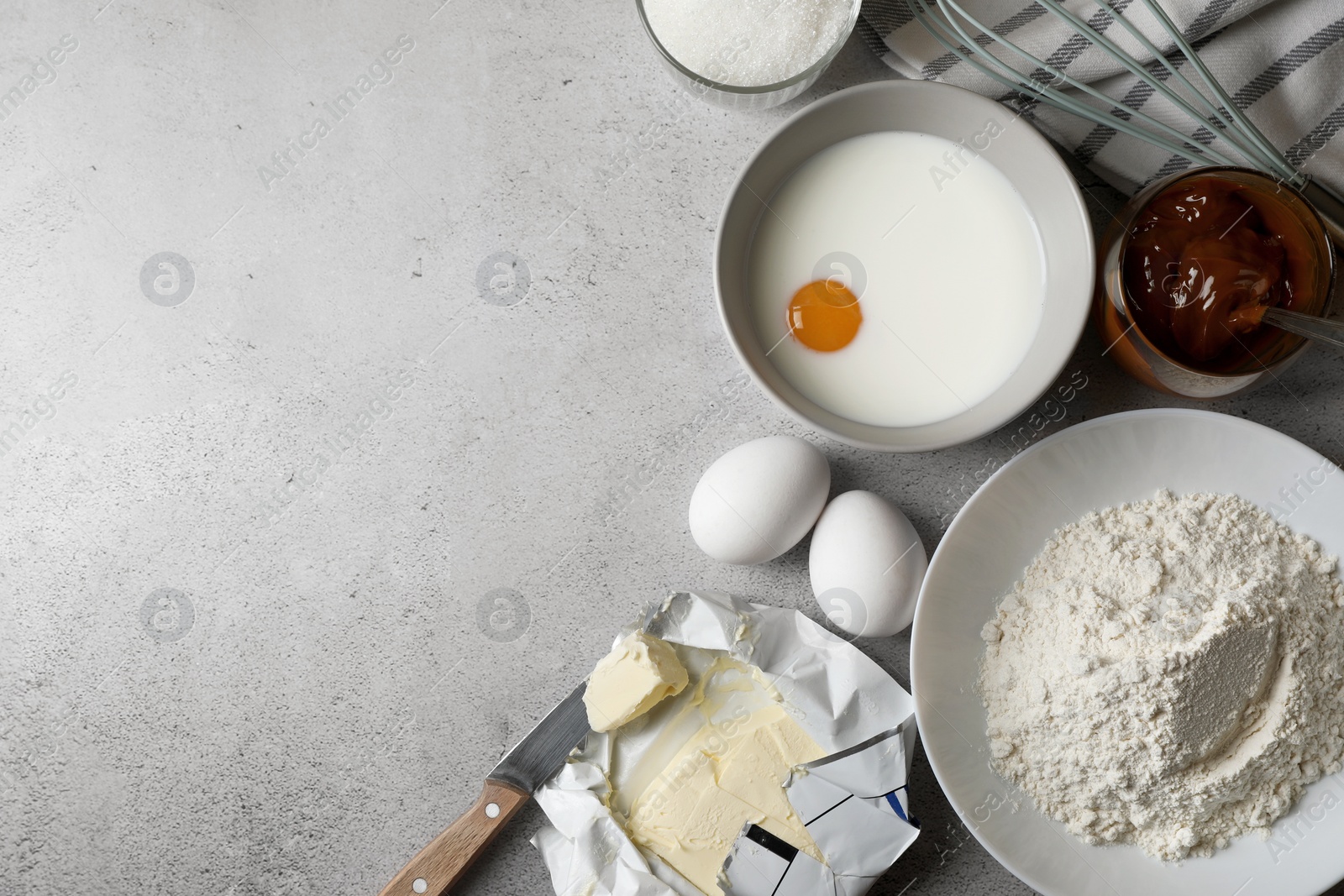 Photo of Ingredients for homemade walnut shaped cookies on grey table, flat lay. Space for text