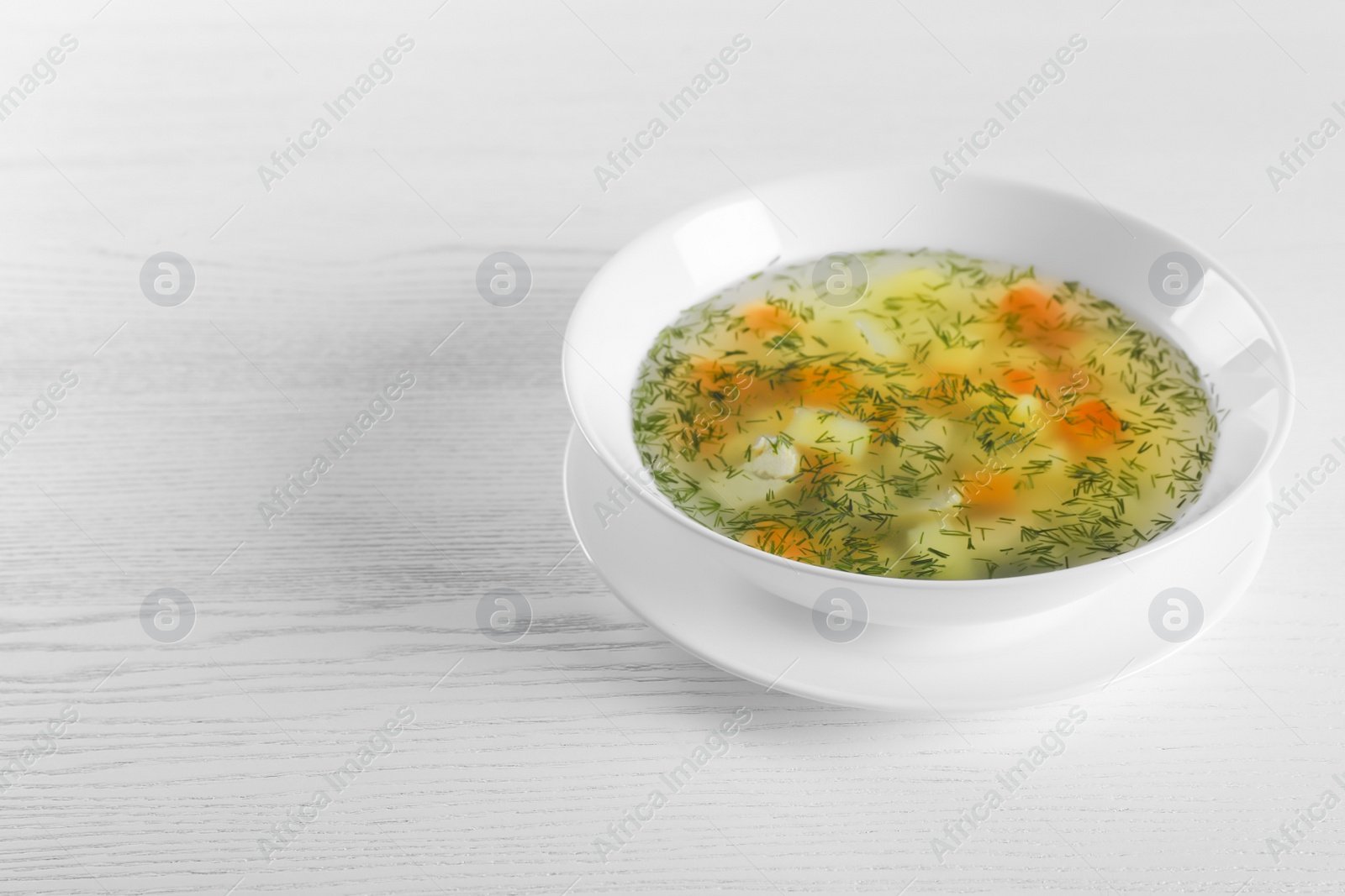 Photo of Bowl of fresh homemade soup to cure flu and space for text on wooden background