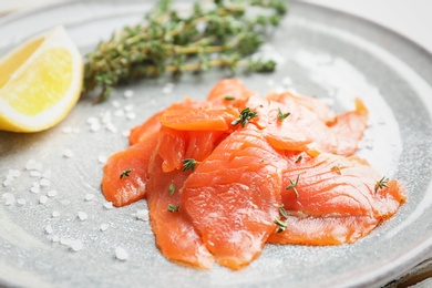 Photo of Plate with fresh sliced salmon fillet, closeup