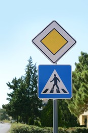Pedestrian Crossing and Priority road signs outdoors
