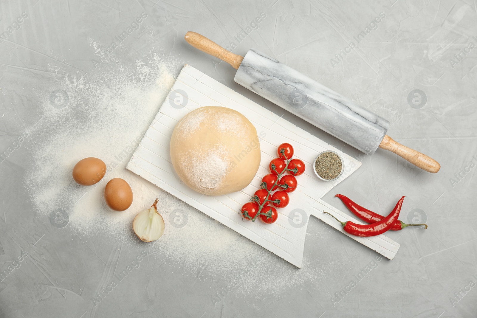 Photo of Dough and ingredients for pizza on table, top view