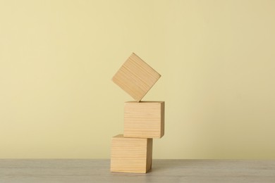 Photo of Stack of wooden cubes on table. Harmony and balance concept