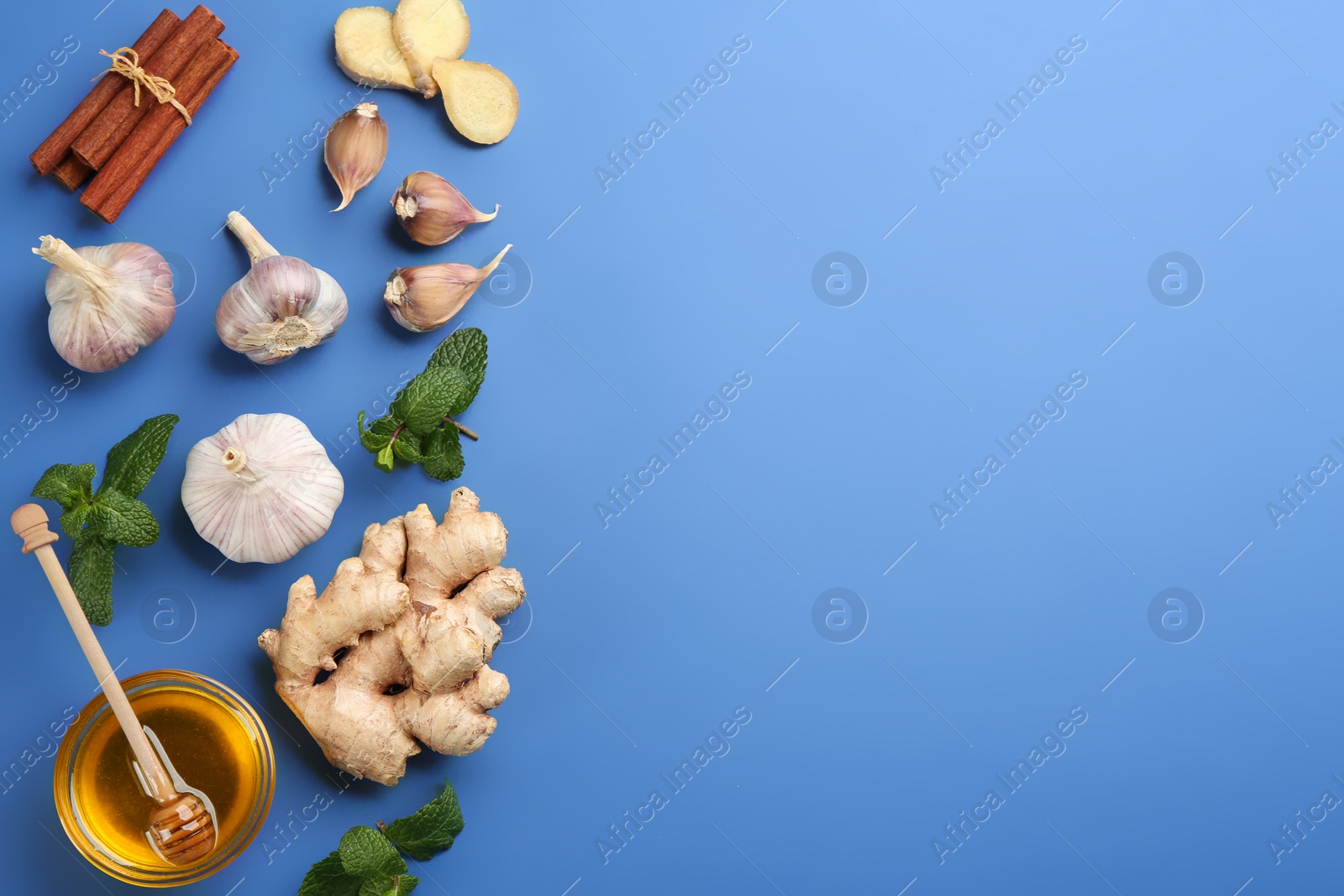 Photo of Flat lay composition with fresh products on blue background, space for text. Natural antibiotics