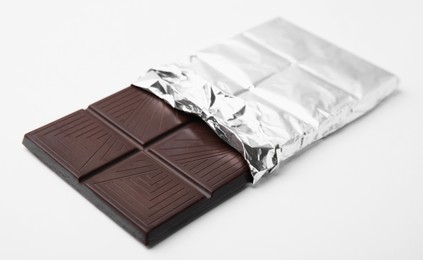 Photo of One tasty chocolate bar on white background