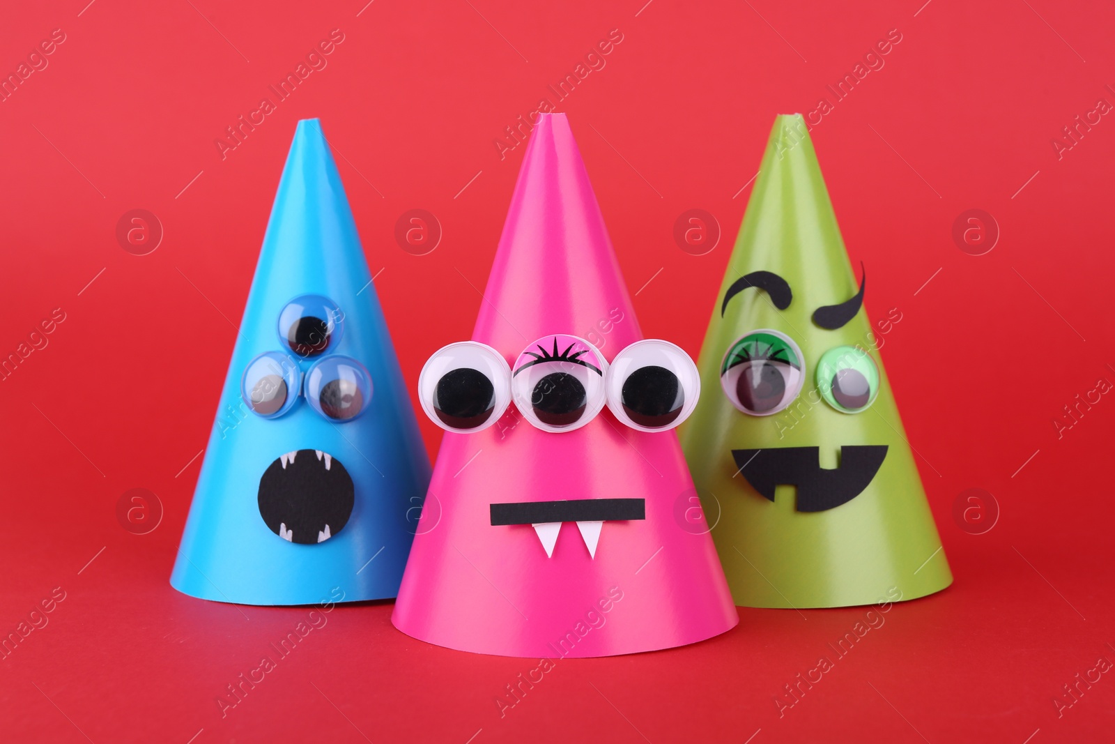 Photo of Spooky paper Halloween monsters on red background