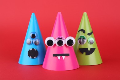 Photo of Spooky paper Halloween monsters on red background