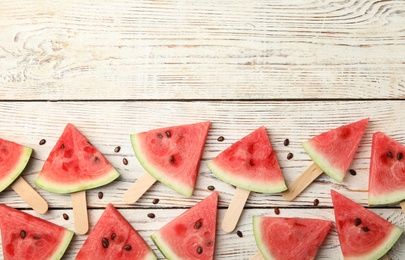 Slices of ripe watermelon on white wooden table, flat lay. Space for text