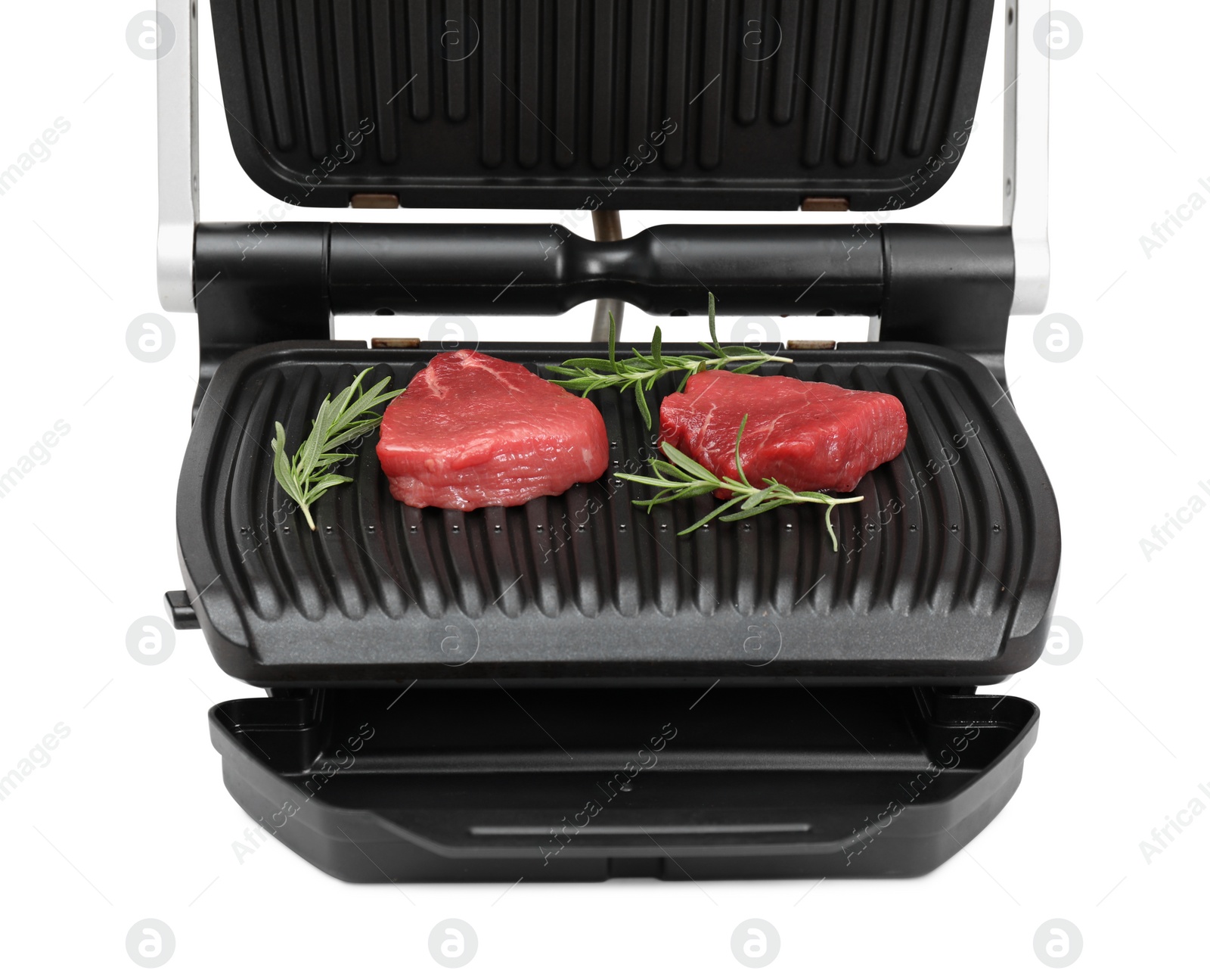 Photo of Electric grill with raw meat steaks and rosemary isolated on white