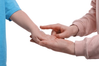 Photo of Mother applying ointment onto her son`s hand on white background, closeup