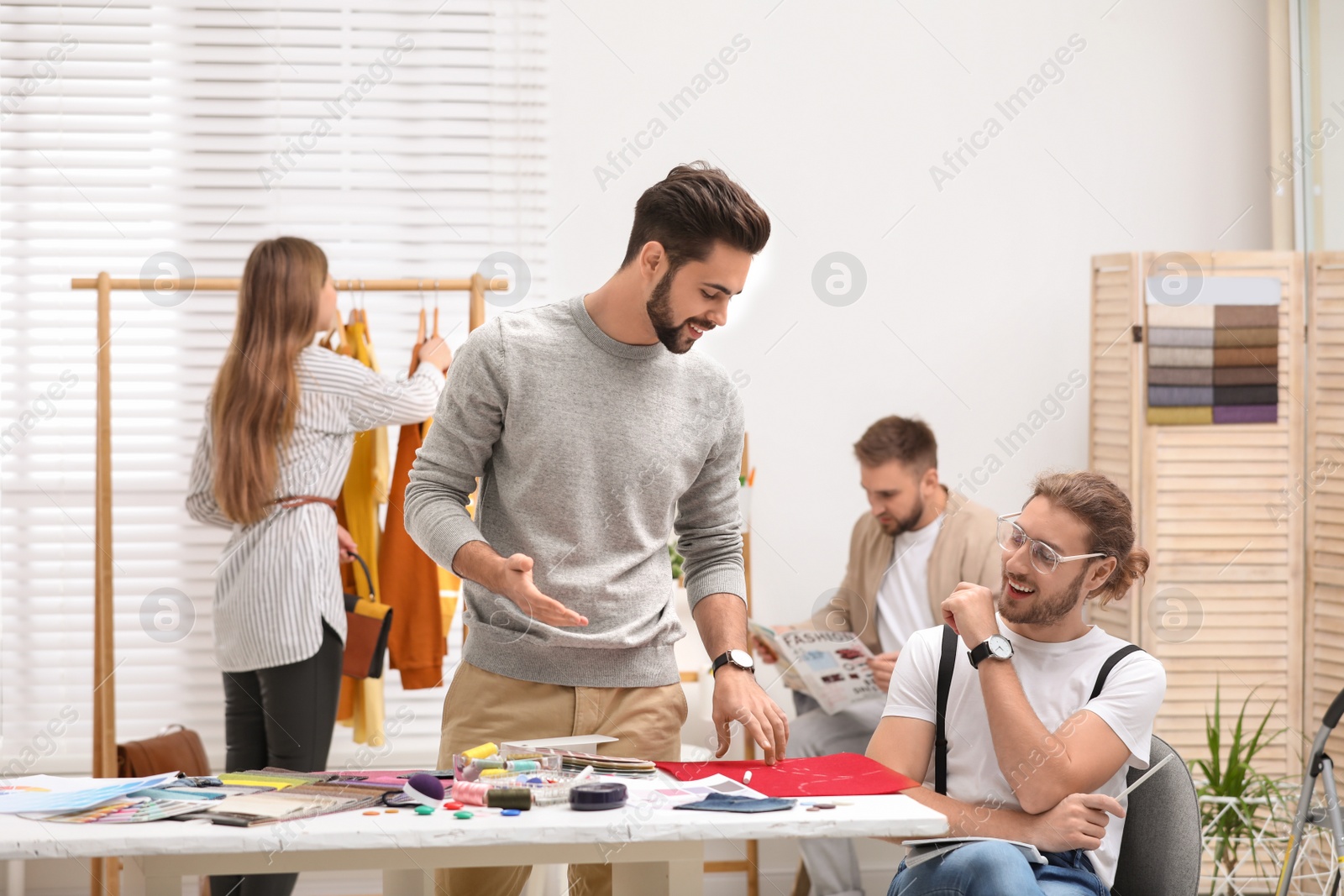 Photo of Fashion designers creating new clothes in studio