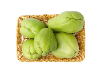 Photo of Fresh green chayote in wicker basket isolated on white, top view
