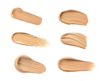 Image of Set with different shades of liquid skin foundation on white background, top view 