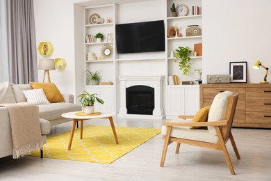 Photo of Spring atmosphere. Stylish room interior with cozy furniture and fireplace