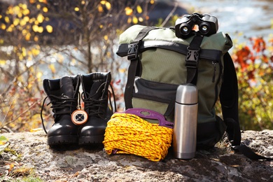 Photo of Set of camping equipment on ground outdoors