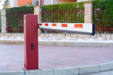 Photo of Closed boom barrier near road on autumn day outdoors