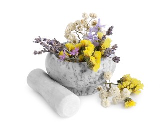 Marble mortar with different flowers and pestle on white background