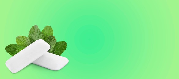 Image of Menthol chewing gum pillows and mint leaves on green gradient background, space for text. Banner design