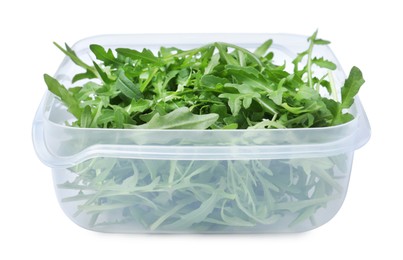 Fresh arugula in plastic container isolated on white