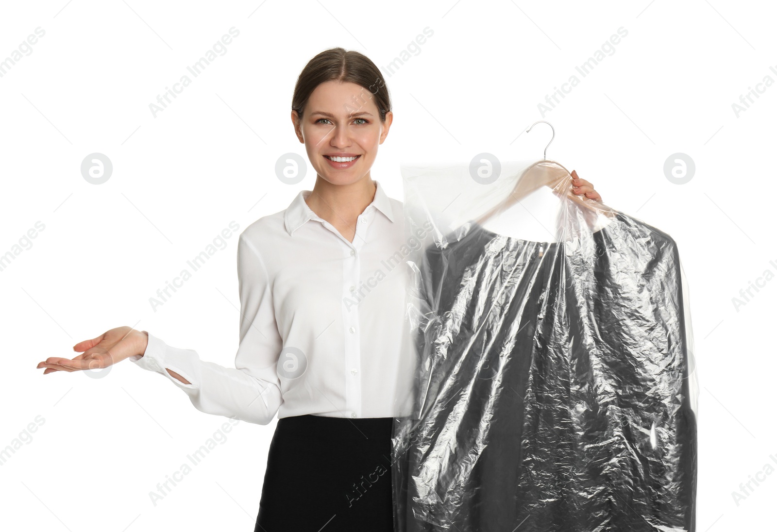 Photo of Young woman holding hanger with dress in plastic bag on white background. Dry-cleaning service