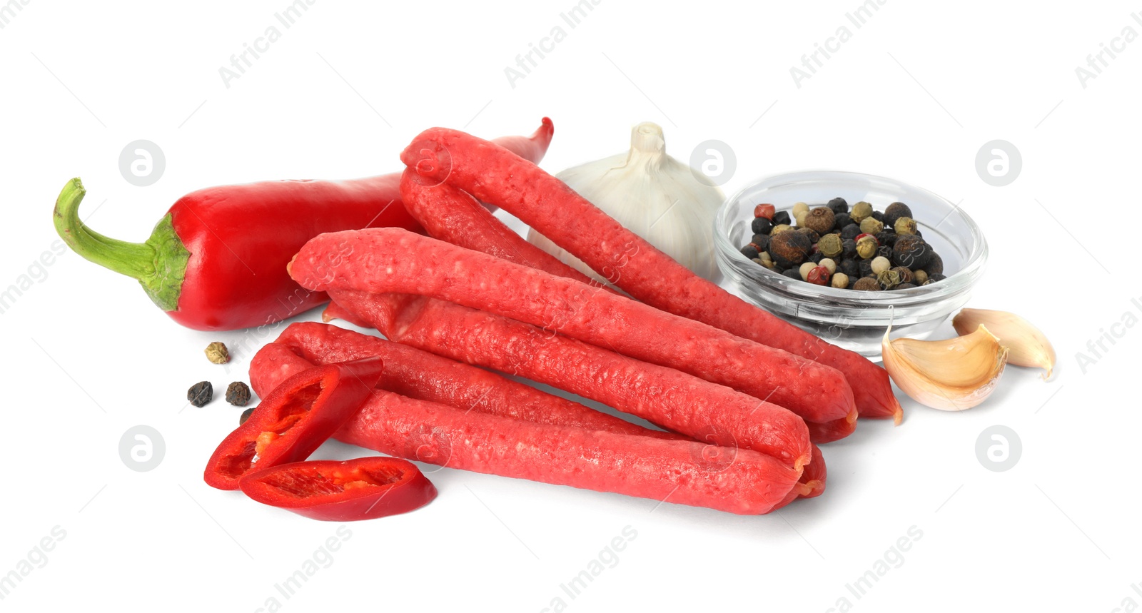 Photo of Thin dry smoked sausages and different spices isolated on white