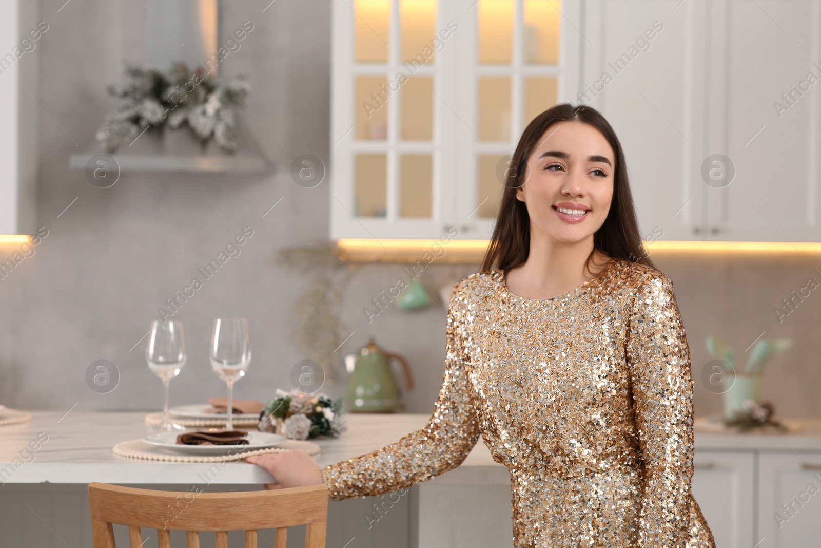 Photo of Christmas mood. Happy woman wearing festive dress in kitchen. Space for text