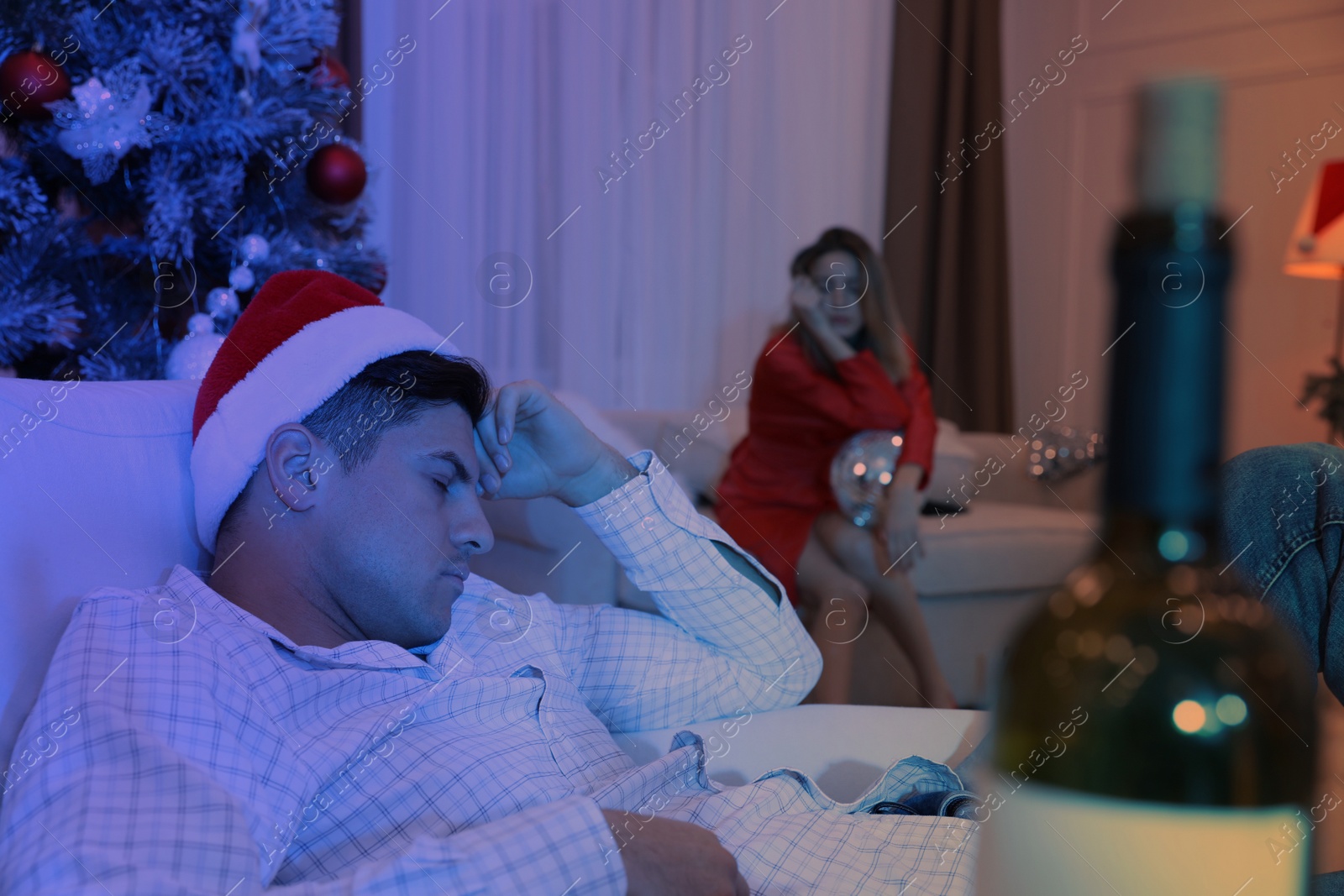 Photo of Man sleeping in messy room after New Year party