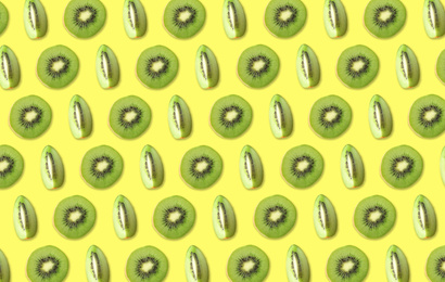 Image of Pattern of cut kiwi fruits on pale yellow background