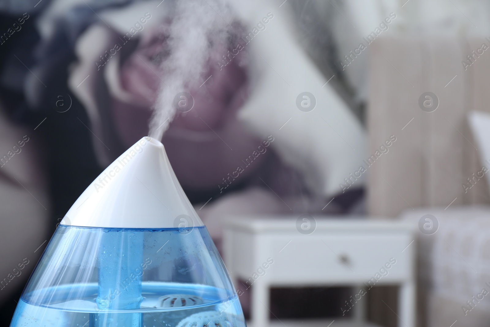 Photo of Modern air humidifier indoors, closeup. Space for text