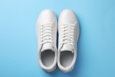 Pair of sneakers on color background, flat lay