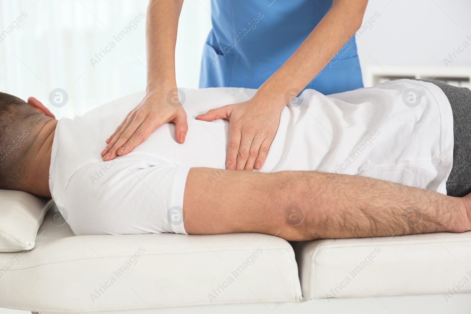 Photo of Doctor working with patient in hospital, closeup. Rehabilitation massage